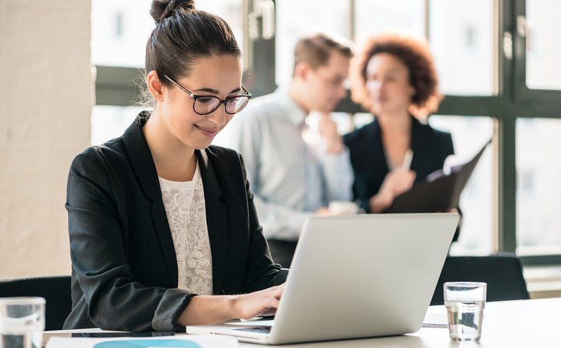 A Skyline Acquisitions representative focused on campaign work at a laptop