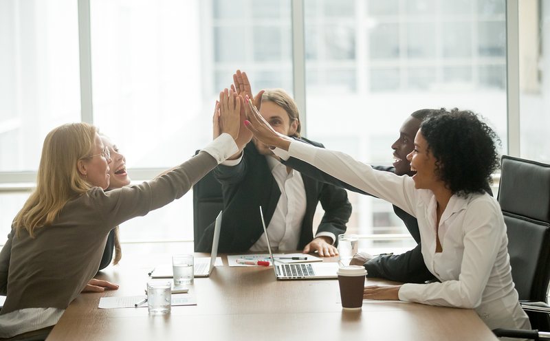 Skyline Acquisitions team members celebrating a sales milestone together